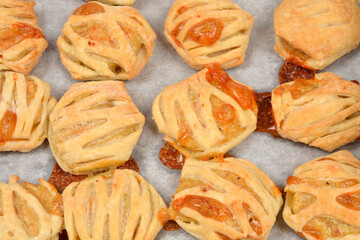 A close-up view of fresh-baked puff pastry with meat filling in a lattice pattern, displayed on...