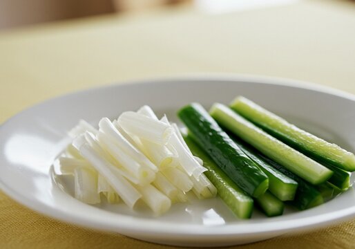 Fresh Sliced Cucumber Sticks and White Leeks on a Plate.