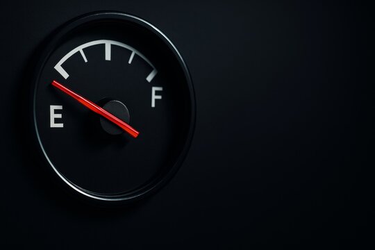 Close-up of empty fuel gauge with red needle on dark background, showing warning sign for low fuel level and transport concept with copy space. Ai generative