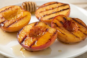 Three grilled peaches with honey drizzled on top