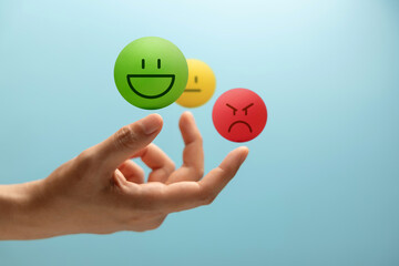 Hand balancing Colorful emotional faces Ball, symbolizing mental health and emotional self-regulation through balancing positive and negative emotions