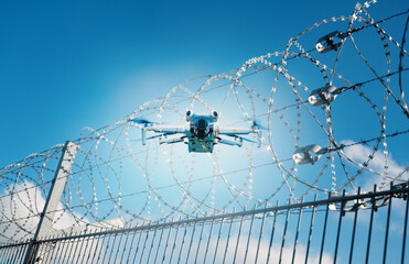 Drone flight at airport, barbed wire, border control, illegal object, coils of razor wires, danger...