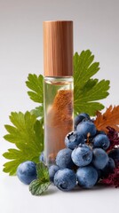 Essential oil roller bottle with blueberries and green leaves on a white background