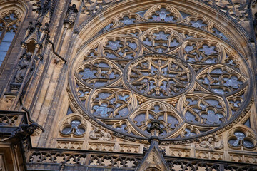 Obraz premium Detailed Gothic facade of St Vitus Cathedral with rose window in Prague, Czech Republic. Concept of religion, heritage and medieval architecture