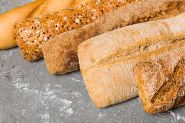 Homemade natural breads. Different kinds of fresh bread as background, perspective view with copy space