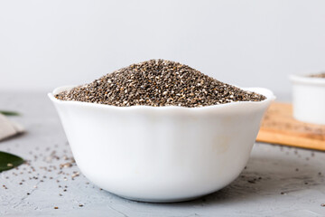 Chia seeds in bowl on colored background. Healthy Salvia hispanica in small bowl. Healthy superfood