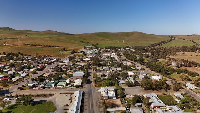 Burra, South Australia &ndash; Aerial Drone Image of Historic Pastoral Town, Country Houses, Estates, Streets, Canola Fields, and Wind Turbines in the Mid-North Agricultural Region
