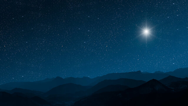 a Christmas star shines at night over the mountains of Bethlehem