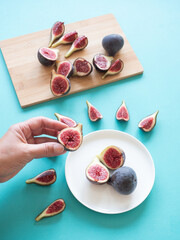 Hand holding fresh cut fig fruit, healthy food