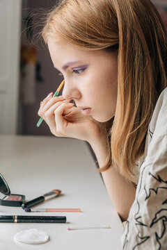 Woman Applying Purple Eyeshadow - Focused Closeup at Home Vanity