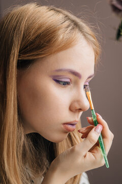 Woman Applying Purple Eyeshadow - Macro Beauty Portrait