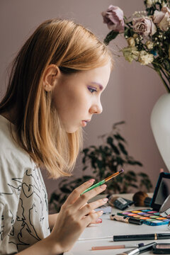 Young Woman Doing Makeup at Home - Side Profile with Brush