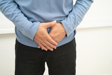 Hernia, Asian man stomach ache, abdominal pain and urology problem health.