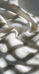Soft white fabric draped, sun-dappled shadows
