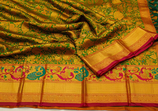 Detailed close-up of a luxurious green Paithani saree pallu, featuring intricate gold zari weaving, traditional peacock motifs, and vibrant silk fabric.