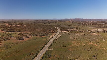 Arkaba Hill Lookout, Flinders Ranges, South Australia – Aerial Drone Image of Rugged Red Cliffs, Rocky Hills, Forest, and Expansive Outback Valleys under Clear Blue Skies in Australia Inland