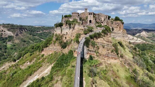 Aerial drone footage of Civita di Bagnoregio, the famous &lsquo;dying town&rsquo; in Lazio, perched on a hilltop with dramatic surrounding valleys.