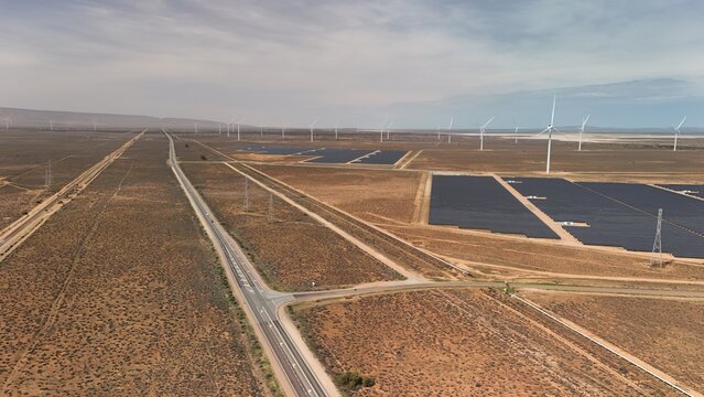 Port Paterson, South Australia – Aerial Drone View of Renewable Energy Farm Featuring Solar Panels, Wind Turbines, Desert Landscape, and Blue Coastal Horizon near Spencer Gulf, Augusta Highway