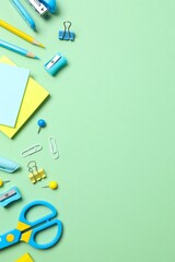 School supplies on green background