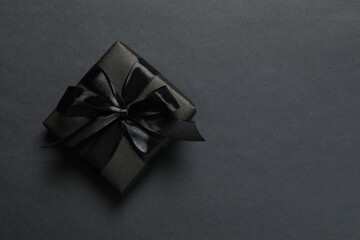 Top view image of black gift box against a dark background. Space for promotional content