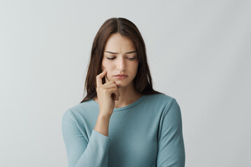 Beautiful young woman thinking with hand on chin