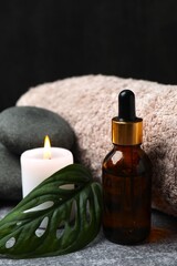 Herbal therapy, traditional medicine and homeopathy concept. Bath towel, candles and bottle natural organic oil essence. Set for spa, massage and aromatherapy 