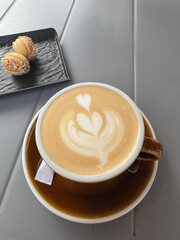 Top view of cup of cappuccino on the table in a cafe, close up
