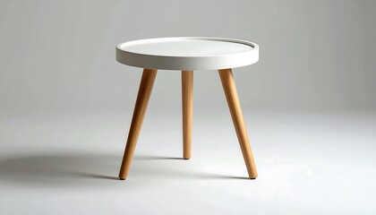 Small, white, round side table with three light wood legs casting a soft shadow against a neutral gray background