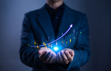 Businessman holding glowing upward graph with bar chart, symbolizing business growth, financial success, investment strategy, economic development, and data analytics in digital era.
