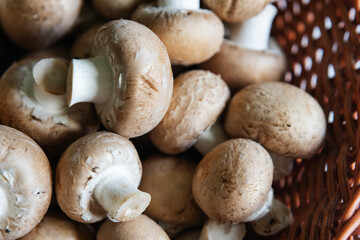 Fresh brown mushrooms in a wicker basket ready for cooking or adding to dishes