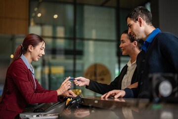 Concierge helping hotel guests during registration, representing excellence in hospitality and customer experience.