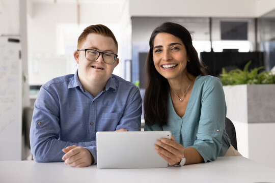 Two happy successful diverse employees of inclusive company working together - Powered by Adobe