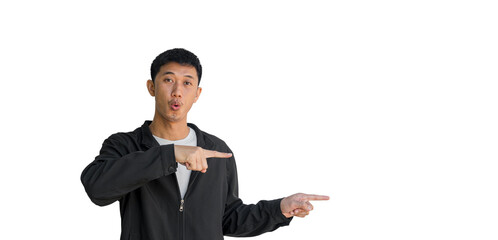 Shocked face young Asian man in black coat pointing thumbs up isolated on a white background. The person's index finger pointing to a blank space for text
