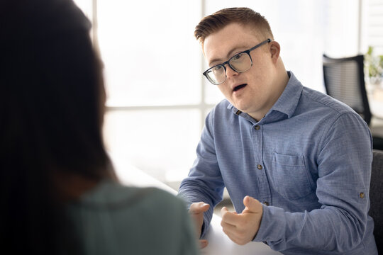 Job candidate man with Down syndrome talking to recruit specialist