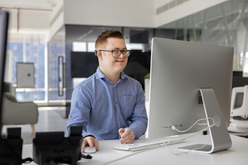 Happy young inclusive company worker man having Down syndrome