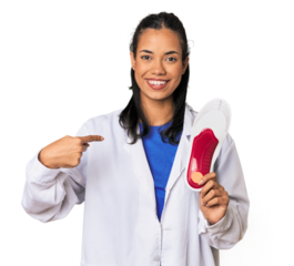 Young Filipina podiatrist with insole person pointing by hand to a shirt copy space, proud and confident