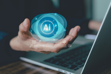 Digital transformation concept. Hand holds a glowing AI symbol over a laptop, representing innovation, future technology, machine learning, data search business. Generative artificial intelligence.