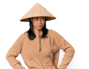 Young Filipina with Vietnamese hat confused, feels doubtful and unsure.