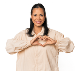 Young Filipina woman smiling and showing a heart shape with hands.
