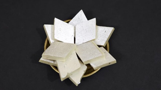 indian traditional sweet Diamond Shaped Cashew Fudge or kaju katli In a Bowl at indoor