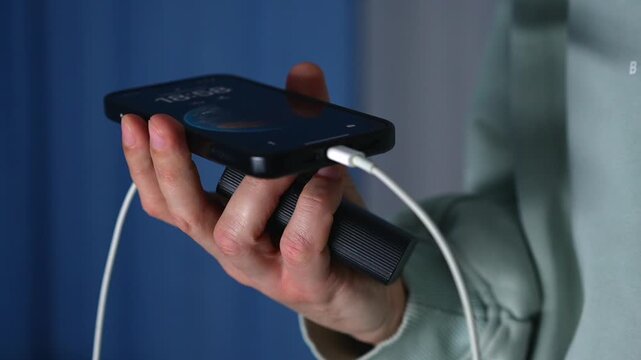 Connecting a USB cable to a smartphone.
A man holding a portable mobile phone charger.
A dead smartphone battery.
Low battery on a mobile phone.