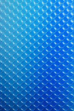 Blue glass panel matrix with circular reflections and 3d effect