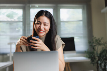 Young woman smiling enjoying virtual online call