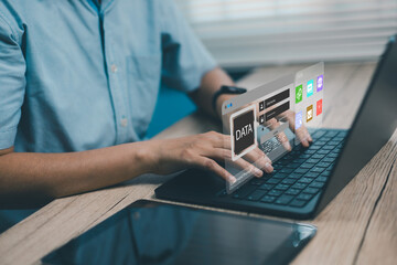 Person typing on laptop with virtual data management interface, big data analytics, cloud storage, artificial intelligence, and digital technology concept for business finance innovation