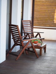 wooden chairs and a table on the terrace