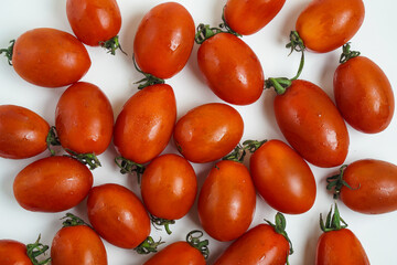 Fresh Harvest Ripe Roma Tomatoes Displayed on White Background