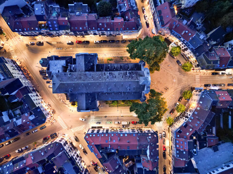 Aerial view of the Ã‰glise Saint-Gilles's symmetrical architecture glows warmly amidst the geometric layout of streets and buildings, Saint-Gilles, Bruxelles, Belgium.