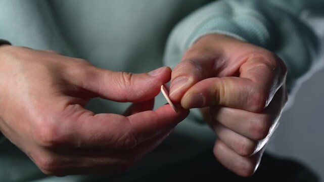 Nail file.
Using a nail file to smooth and polish sharp edges on the nail plate after trimming.