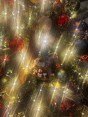 Close-up of a decorated Christmas tree with sparkling ornaments and glowing lights. Festive and cozy holiday atmosphere symbolizing Christmas celebration, family traditions, and winter mood.