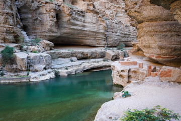 Wadi Shab beautiful gorge with turquoise water and waterfall, popular hiking in Oman